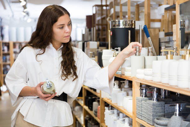 istock Female buyer choosing bottle for liquid soap 1324553478