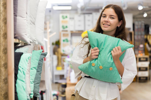 istock Woman choosing pillow in home textile shop 1324553516