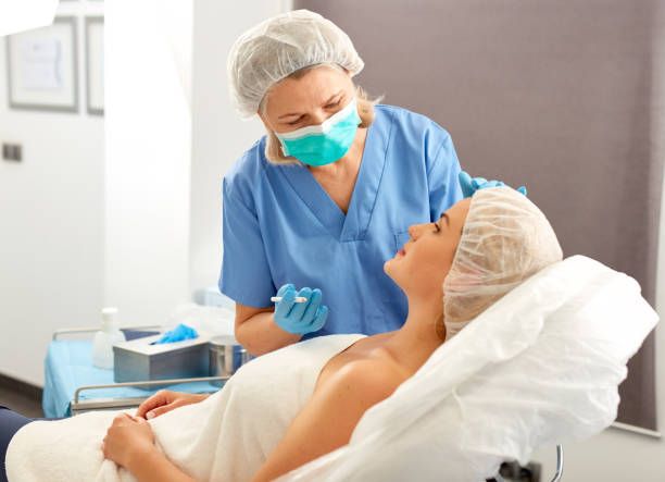 istock Plastic surgeon preparing for operation on woman face 1324555065