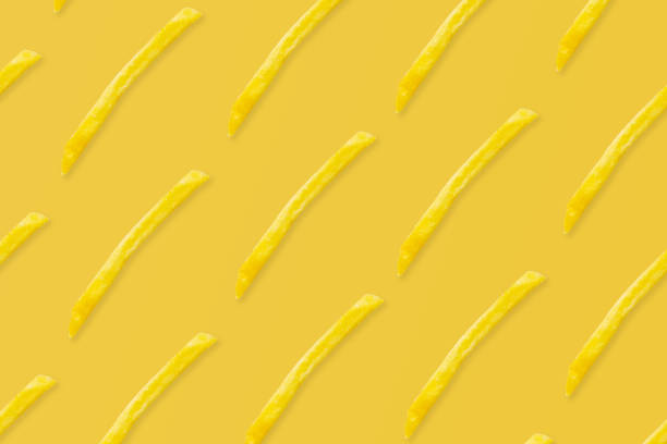 istock french fries pattern on yellow background top view flat lay 1324558665