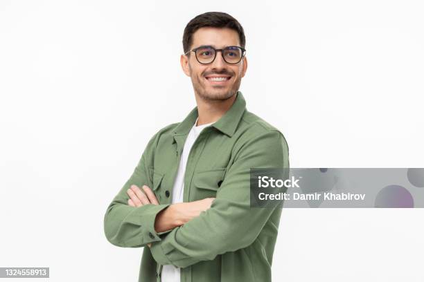 Confident Young Man In Casual Green Shirt Looking Away Standing With Crossed Arms Isolated On Gray Stock Photo - Download Image Now