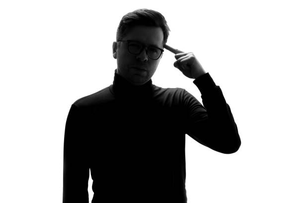 istock Silhouette of businessman considers his options, thinking about important project. 1324559045