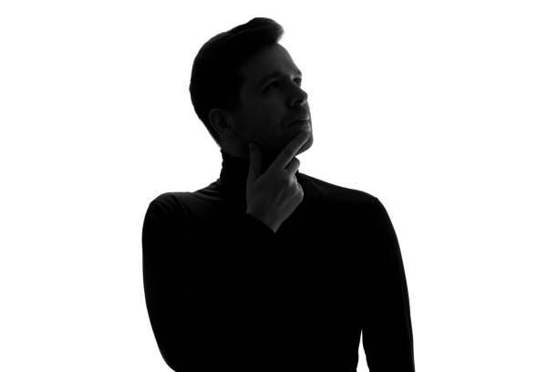 istock Silhouette of businessman considers his options, thinking about important project. 1324559056