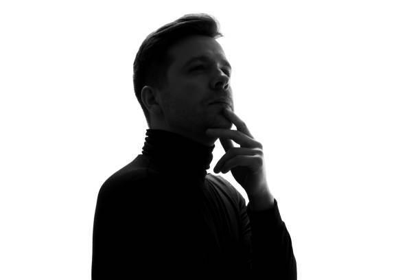 istock Silhouette of businessman considers his options, thinking about important project. 1324559067