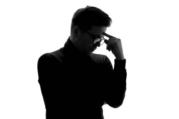 istock Silhouette of businessman considers his options, thinking about important project. 1324559081