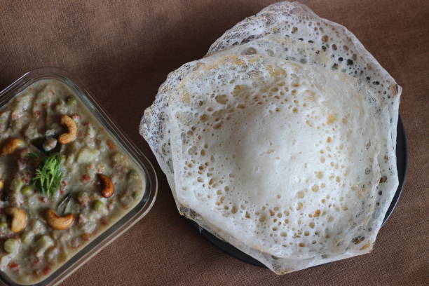 istock Fermented rice pancakes made with fermented rice batter and coconut milk served along with mixed vegetable ground coconut cashew gravy. Favourite of South Indians 1324559846
