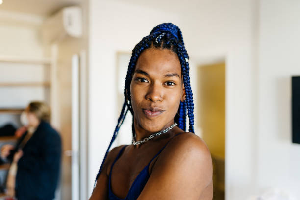 portrait of a transgender woman at home - transgender stockfoto's en -beelden