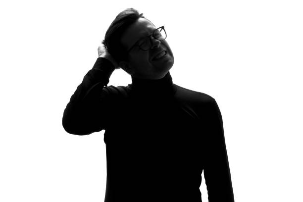 istock Silhouette of young man having headache isolated over white background. 1324560956