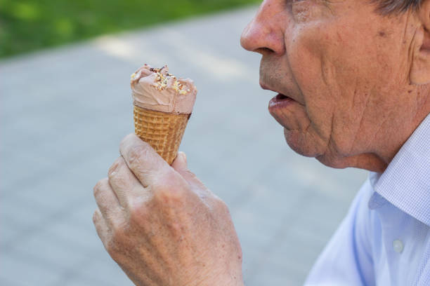 istock Happy senior Man eating ice cream 1324562649