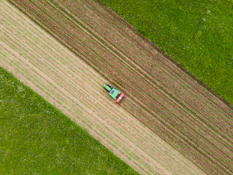 Aerial View on Tractor Working on Agricultural Field.
