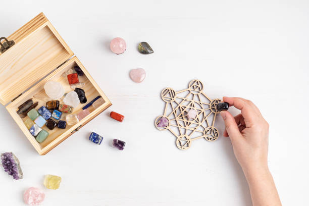 istock Healing chakra crystal grid therapy. Rituals with gemstones and aromatherapy for wellness, healing, meditation 1324566107