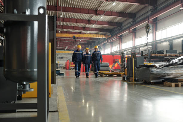 istock Team of factory workers crossing compressor plant workshop 1324567113
