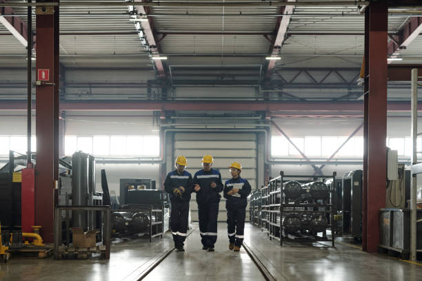 istock Plant workers discussing production of air compressors 1324567151