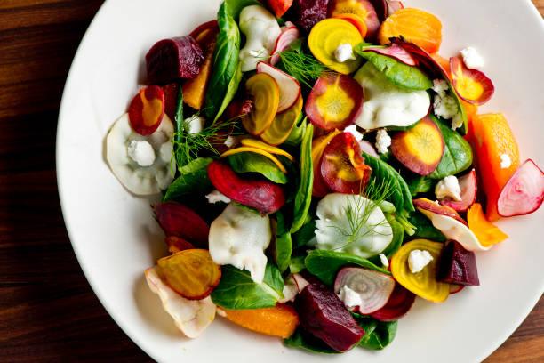 istock Beet salad. Classic Italian salad with beets, mozzarella, spinach, arugula, Parmesan cheese, olive oil, lemon juice, salt and pepper. A Fine dining restaurant classic. 1324569054