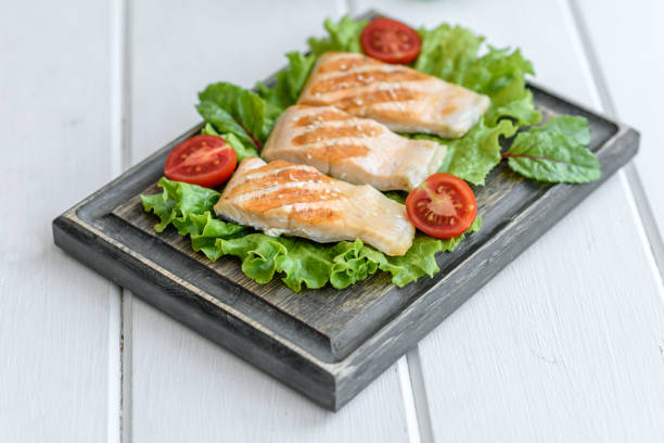 istock Delicious fresh salad with fish, tomatoes and lettuce leaves 1324570187