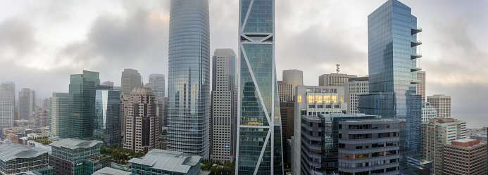 San Francisco Financial District panorama with summer fog rolling in via apartment building rooftop.