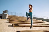 Fit Young woman in sportswear doing yoga, fitness exercise on the street.