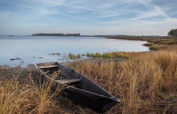 istock Boats on the shore among dry grass. 1324574894