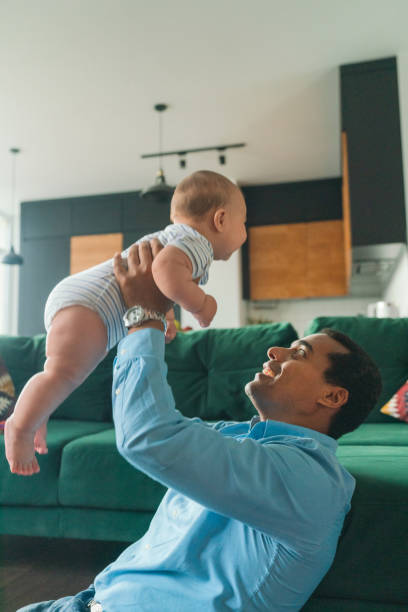 istock Father playing with son at home 1324579767