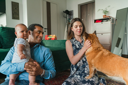 Mixed race family with two children at home in their apartment