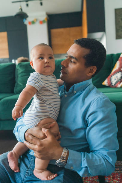 istock Father playing with son at home 1324579775