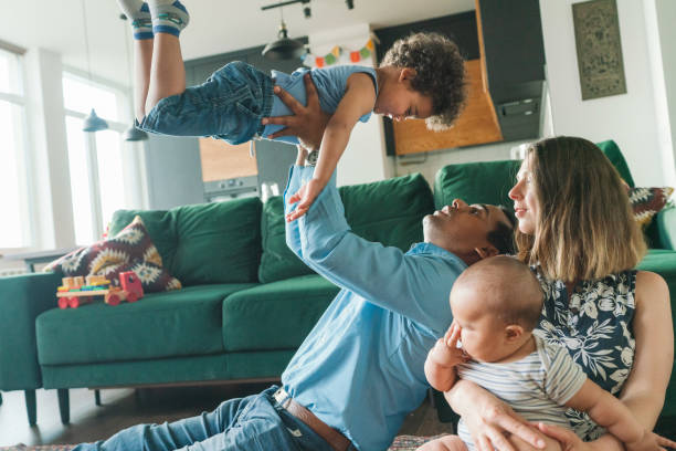 istock Mixed race family with two children at home 1324579783