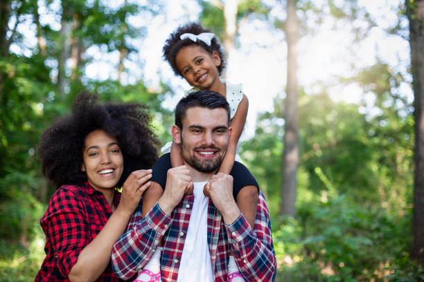 istock Happy family walking along a path in the woods 1324581017