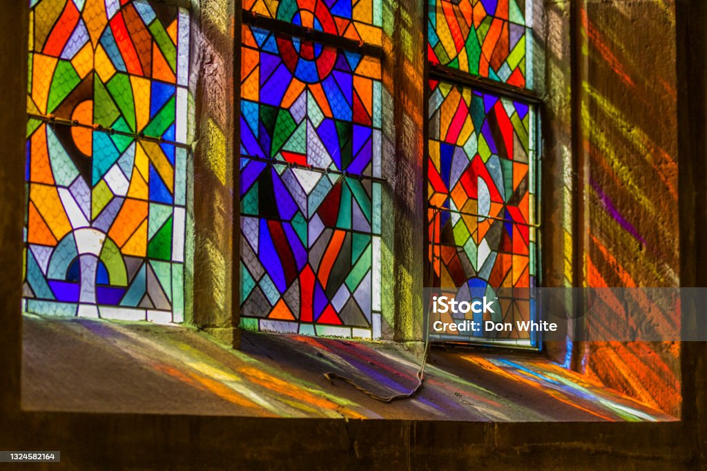 Alsace region of France Sunlight pouring through stained glass windows of a church in Kaysersberg France Stained Glass Stock Photo