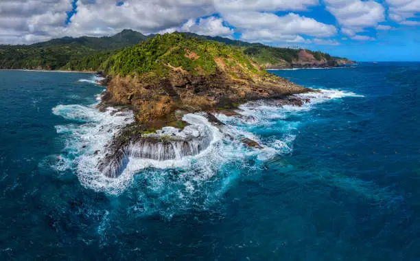 L'Escalier Tete Chien - unusual geological formation called a "Dyke". It is a source of myths and legends about snake stairway. Located on Atlantic side, Carib Territory, Dominica, Eastern Caribbean. Drone panorama, January 2021