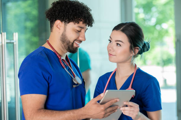 istock Young adult nurses looking at digital tablet together 1324584176