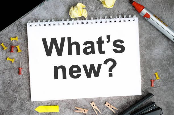 istock What's new text on a white notebook with pins, marker and stapler on a concrete table 1324585523