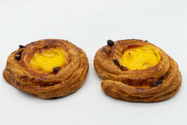 istock Two raisins cream brioches isolated on white background. 1324589337