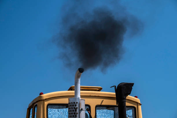 Exhaust fumes from old truck Smoke billows from the old truck. The air pollution is one of the most important problems in the cities. smog car stock pictures, royalty-free photos & images