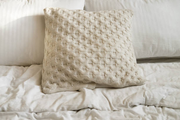 istock bed in the bedroom, white pillows and cozy linens 1324595956