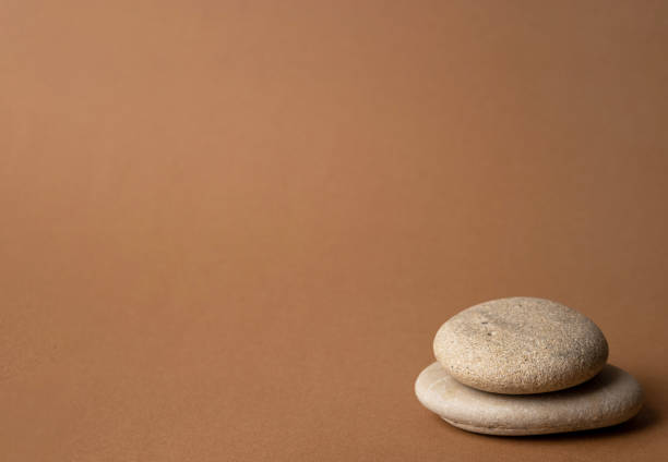 istock Stone cairn on striped brown background, five stones tower, simple poise stones, simplicity harmony and balance, rock zen sculptures 1324603466