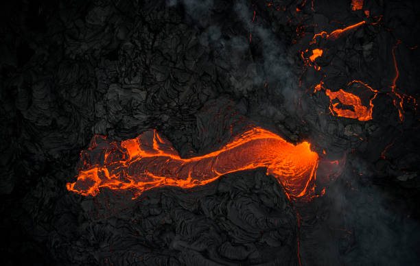 istock Volcanic terrain with hot orange lava 1324603533