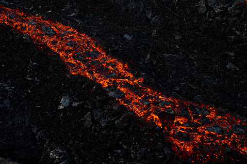 Igneous burning lava flowing on rough ground in Grindavik, Iceland