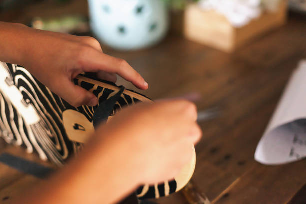 istock Middle Schooler boy applying grip tape to his skateboard. 1324604068