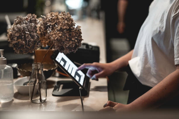 Waitress ordering on point sale with touchscreen stock photo