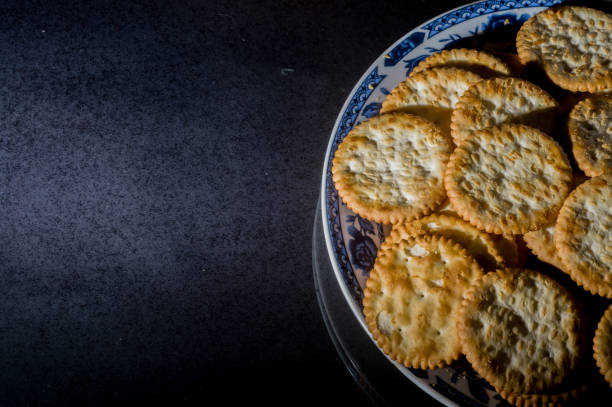 istock Salted crackers on a plate with white background and copy space 1324605639