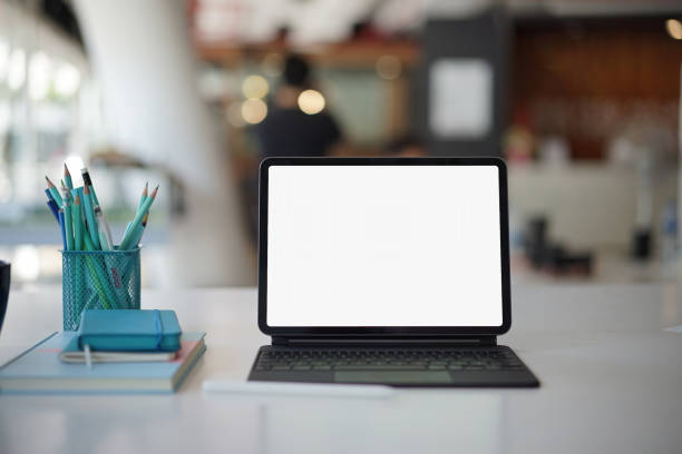 istock Mockup blank screen laptop at workplace. White screen laptop for graphic montage. Clipping path 1324607415