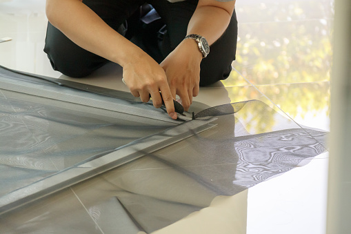 man install mosquito net wire screen on house window protection against insect