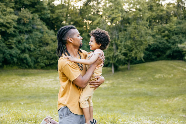 istock Dad hugging his son outdoors 1324609373