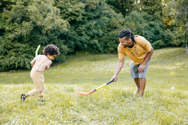 istock Running on the grass with hockey sticks . 1324609405