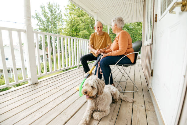 istock Senior couple spending time sitting outdoors with dog 1324609689