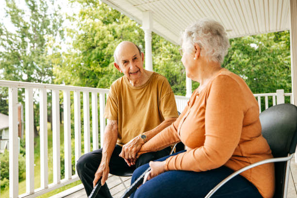 istock Senior couple spending time sitting outdoors with dog 1324609692