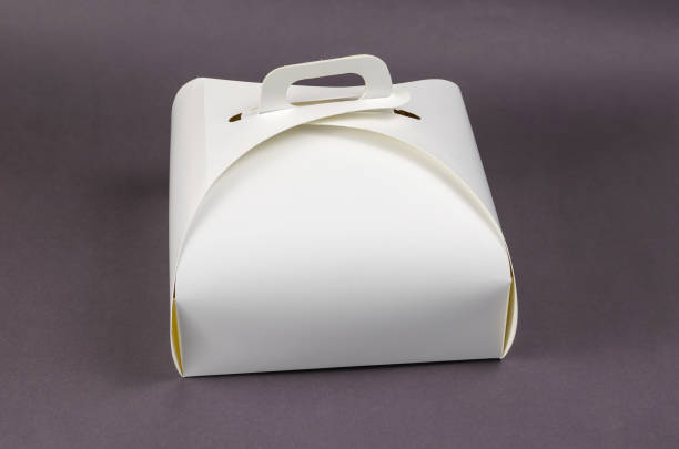 istock White Paper Cake or Lunch Box on Gray. Closed kraft packaging wi 1324610162