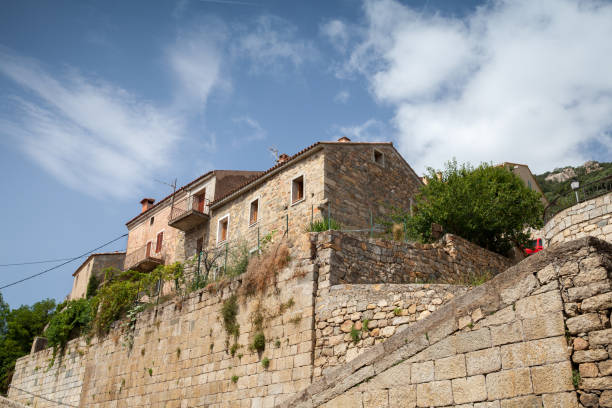 istock Old living houses are under cloudy sky 1324611446