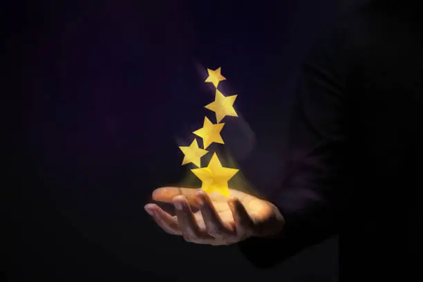 Photo of Success in Business or Personal Talent Concept. Gesture Hand with Golden Five Star Awards