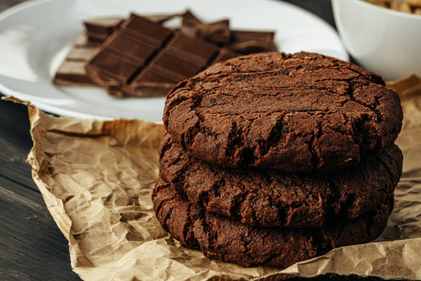 istock Chocolate cookies on dark table close up 1324616984